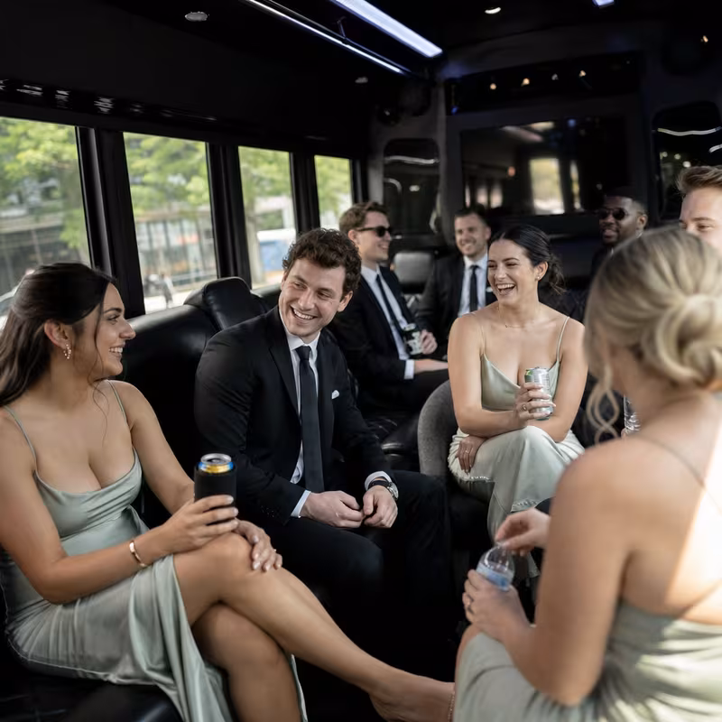 Wedding guests seated inside a Springfield party bus
