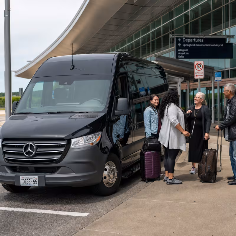 Group boarding a white charter bus for Airport Transportation transportation in Springfield