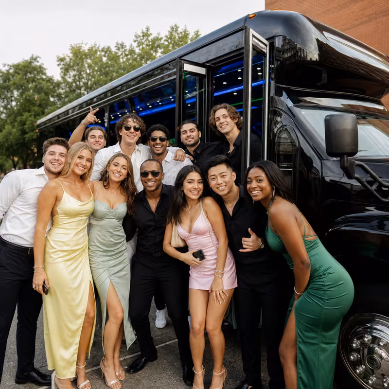 Group boarding a white charter bus for Birthday Transportation transportation in Springfield