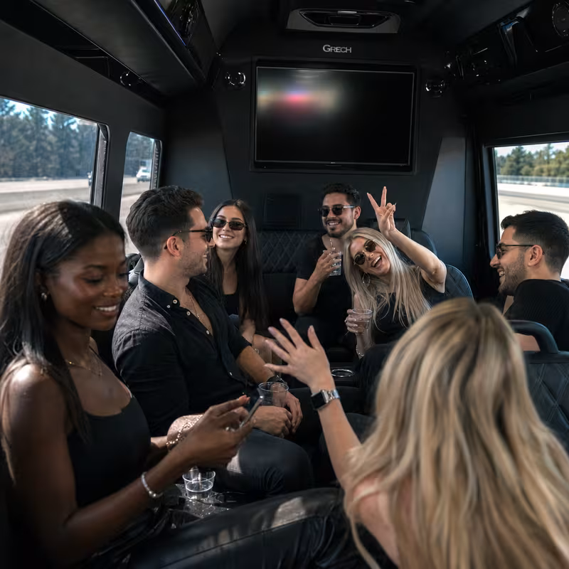 Group boarding a white charter bus for Concert Transportation transportation in Springfield