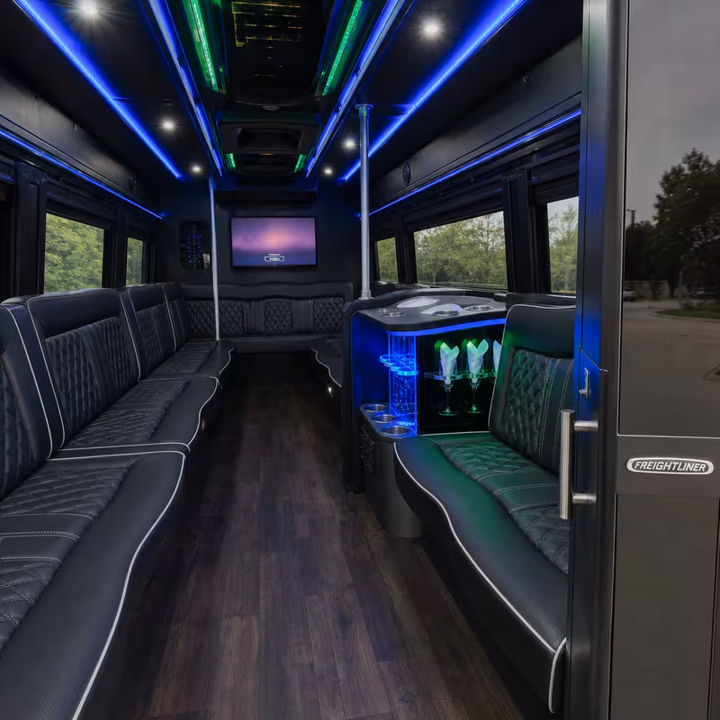 Party bus interior with wraparound leather seating and LED lighting in Springfield