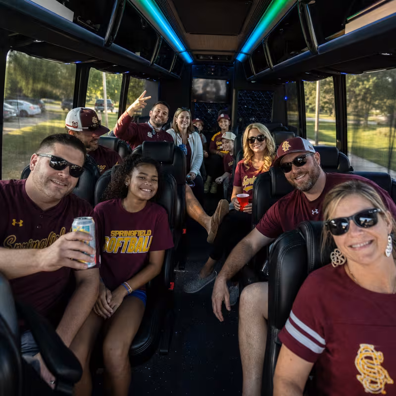 Group boarding a white charter bus for Sporting Event Transportation transportation in Springfield