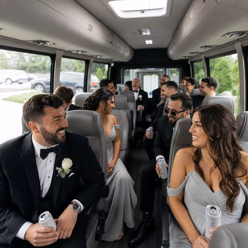 Group boarding a white charter bus for Wedding Transportation transportation in Springfield