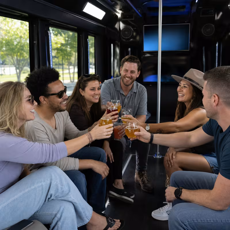 Group boarding a white charter bus for Winery & Brewery Tour Transportation transportation in Springfield