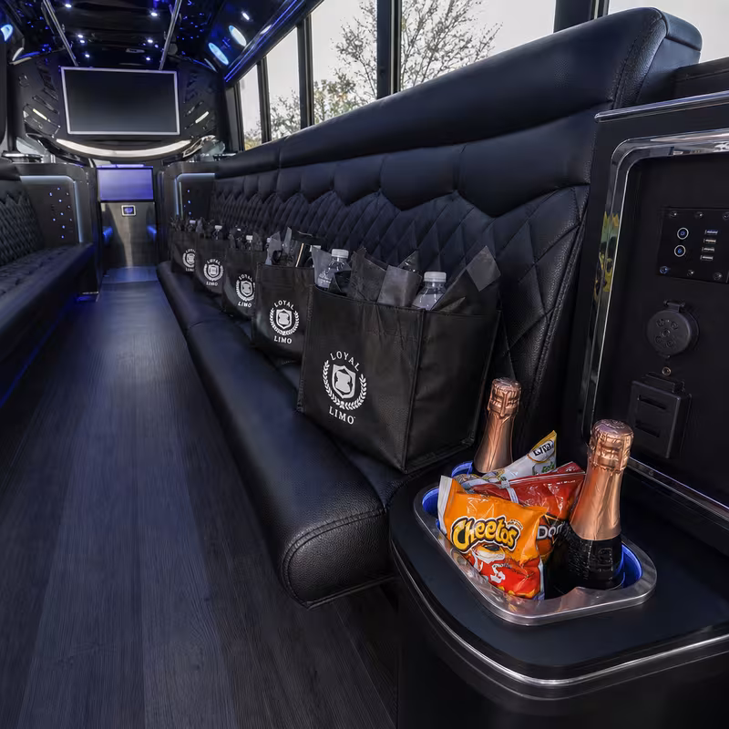 Party bus interior with wraparound leather seating and LED lighting in Springfield